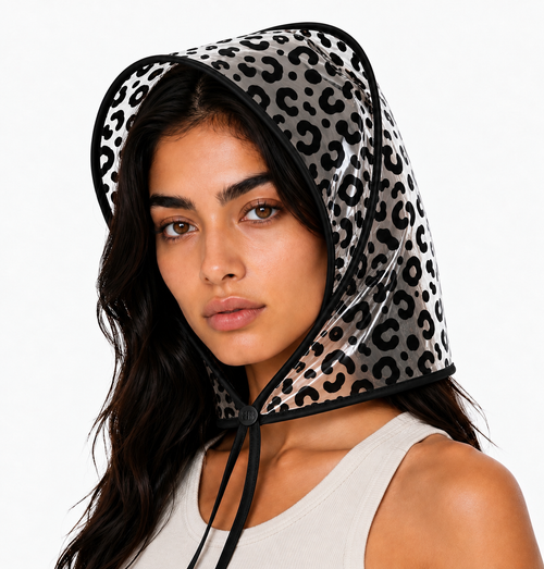 Black leopard print rain bonnet with black trim and chin ties, worn by a model facing the camera.